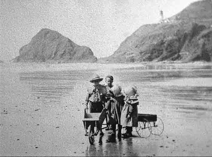 Kids playing on the Beach below Heceta Lighthouse